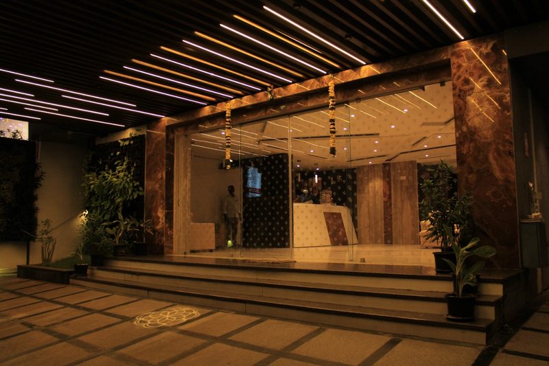 Glass-fronted hotel entrance and reception in the evening